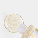Close-up of a clear serum with golden Peptide beads alongside its transparent bottle labeled 'Neogen Real Peptide Serum,' displayed on a white background.