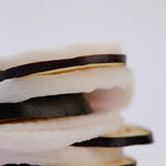 Close-up of Papa Recipe Eggplant Peeling Pads layered with slices of eggplant, showcasing their main ingredient against a white background.
