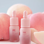 Peripera INK AIRY VELVET 21 and 23 Peaches Collection lip tints displayed amidst soft peach-like backgrounds and slices.