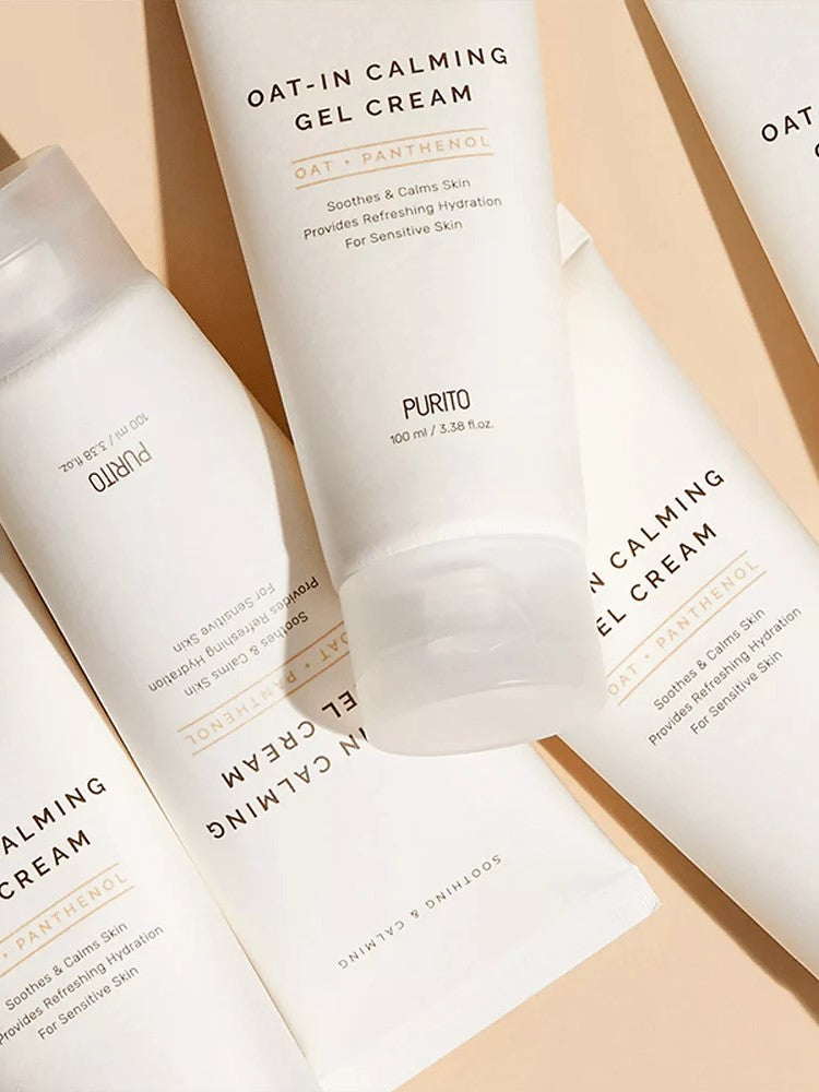 Flat lay of Purito Oat-In Calming Gel Cream tubes, highlighting soothing ingredients for sensitive skin on a soft pastel background.