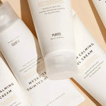 Flat lay of Purito Oat-In Calming Gel Cream tubes, highlighting soothing ingredients for sensitive skin on a soft pastel background.