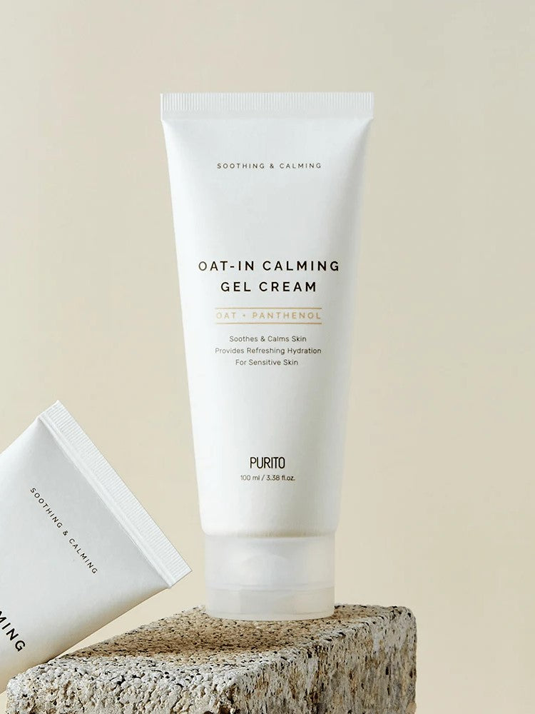 Tube of Purito Oat-In Calming Gel Cream with calming label, placed on a textured stone surface, promoting soothing hydration for sensitive skin.