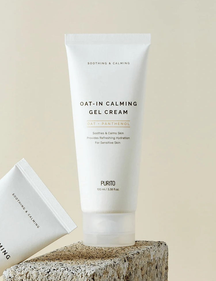 Tube of Purito Oat-In Calming Gel Cream with calming label, placed on a textured stone surface, promoting soothing hydration for sensitive skin.