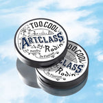 Two Too Cool for School Artclass By Rodin Finish Setting Pacts on a light blue background, highlighting their sleek product design and minimalist aesthetic.