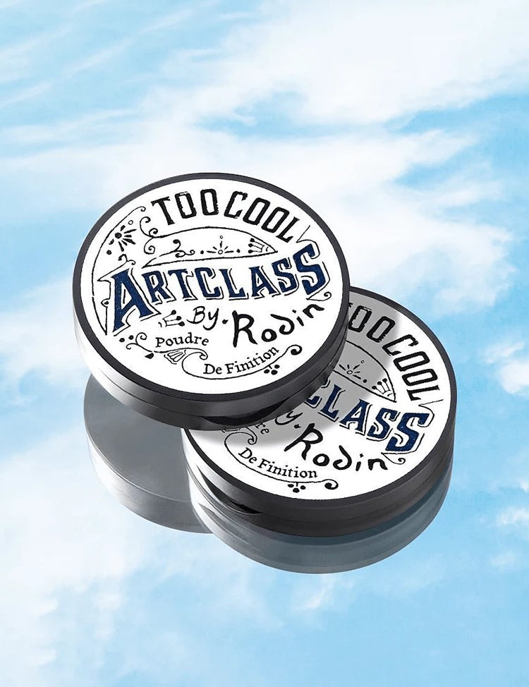 Two Too Cool for School Artclass By Rodin Finish Setting Pacts on a light blue background, highlighting their sleek product design and minimalist aesthetic.