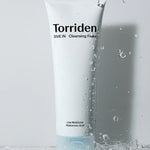 White tube of Torriden DIVE IN Cleansing Foam with water droplets, labeled 'Low Molecular Hyaluronic Acid.