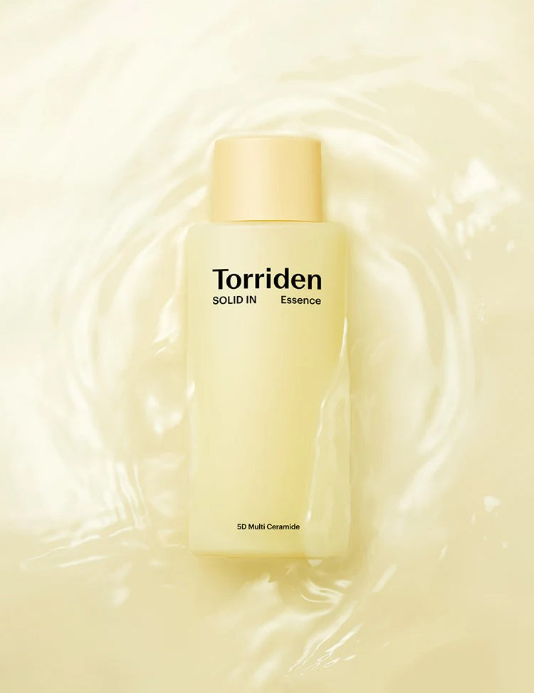 Yellow bottle of Torriden Solid IN Essence with light yellow cap, surrounded by water, highlighting its 5D Multi Ceramide formula.